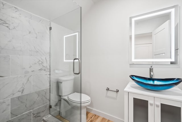 30A Arroyo Coyote Rd, Santa Fe, NM 87508 - bathroom featuring vanity, a shower with shower door, and wood finished floors