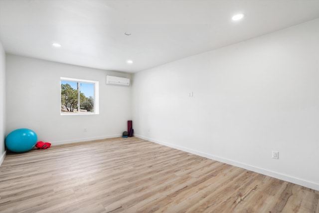 30A Arroyo Coyote Rd, Santa Fe, NM 87508 - workout room with a wall mounted air conditioner, wood finished floors, and recessed lighting