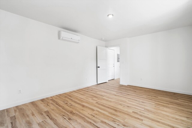 30A Arroyo Coyote Rd, Santa Fe, NM 87508 - spare room featuring a wall unit AC, light wood-style floors, and electric panel