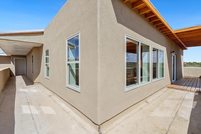 30A Arroyo Coyote Rd, Santa Fe, NM 87508 - view of home's exterior with stucco siding and a patio area