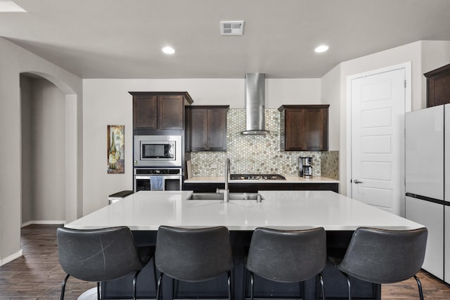 9035 S Sky St NW, Albuquerque, NM 87114 - kitchen with stainless steel appliances, wall chimney exhaust hood, a sink, dark wood-type flooring, and recessed lighting