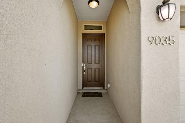 9035 S Sky St NW, Albuquerque, NM 87114 - doorway to property with stucco siding