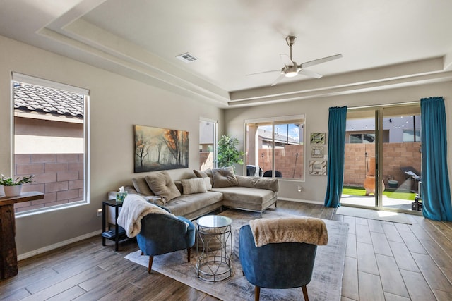9035 S Sky St NW, Albuquerque, NM 87114 - living room with a raised ceiling, wood finished floors, a ceiling fan, and baseboards