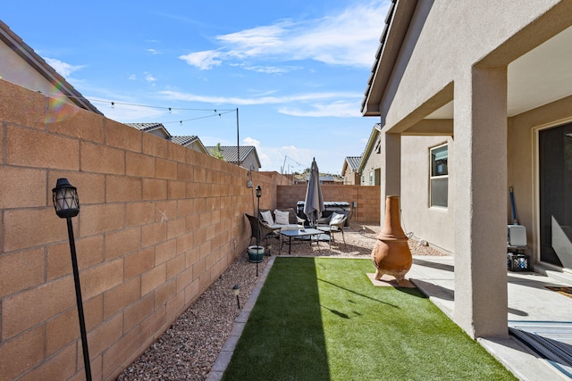 9035 S Sky St NW, Albuquerque, NM 87114 - fenced backyard with a patio and an outdoor living space