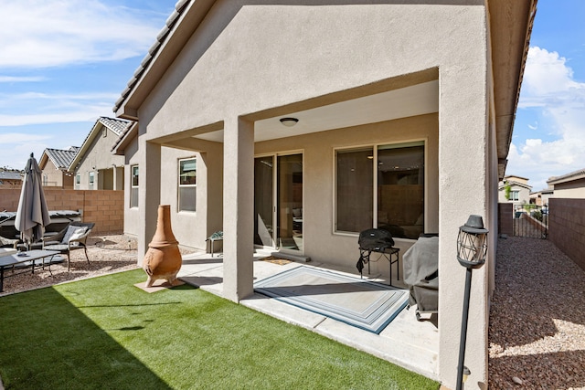 9035 S Sky St NW, Albuquerque, NM 87114 - rear view of property with stucco siding and a patio