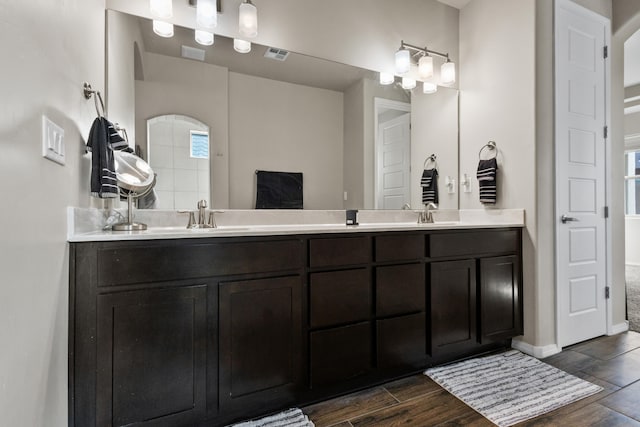 9035 S Sky St NW, Albuquerque, NM 87114 - bathroom featuring wood finished floors, double vanity, and baseboards