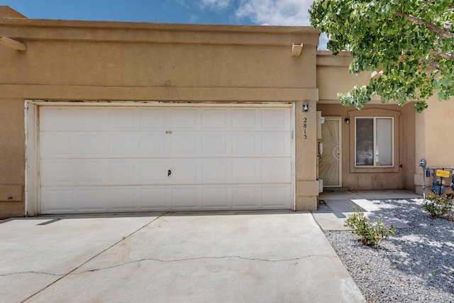 2815 Quail Pointe Dr NW, Albuquerque, NM 87120 - view of front facade with driveway, stucco siding, and an attached garage