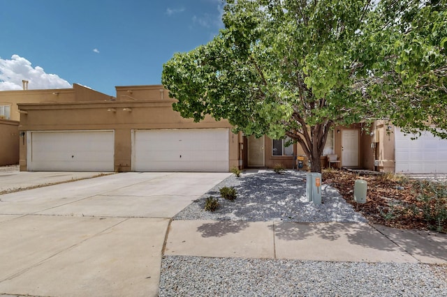 2815 Quail Pointe Dr NW, Albuquerque, NM 87120 - view of front of property with concrete driveway, stucco siding, and a garage