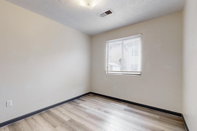 2815 Quail Pointe Dr NW, Albuquerque, NM 87120 - unfurnished room featuring a textured ceiling, light wood-style flooring, and baseboards