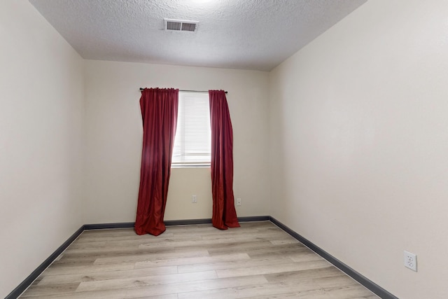 2815 Quail Pointe Dr NW, Albuquerque, NM 87120 - empty room with light wood-type flooring, a textured ceiling, and baseboards