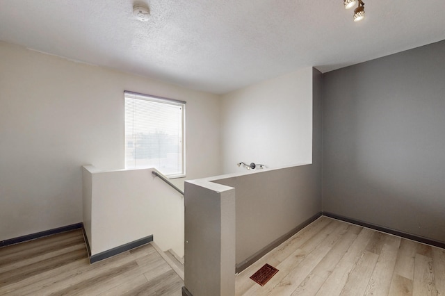 2815 Quail Pointe Dr NW, Albuquerque, NM 87120 - spare room with light wood-style floors, baseboards, a textured ceiling, and a smoke detector