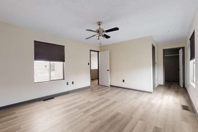 2815 Quail Pointe Dr NW, Albuquerque, NM 87120 - unfurnished bedroom with light wood-type flooring, baseboards, ceiling fan, and a spacious closet
