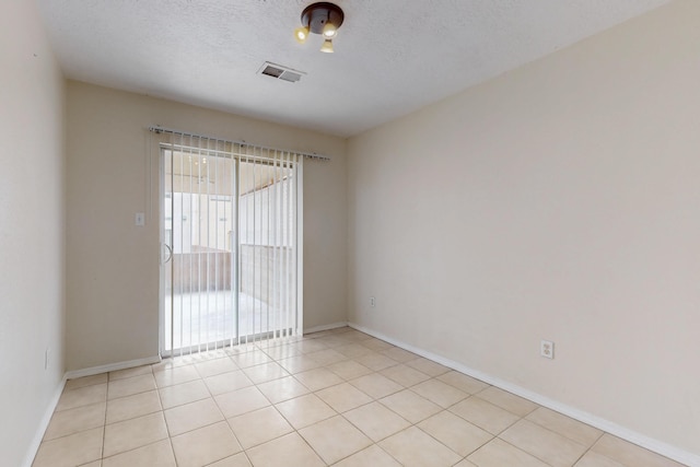 2815 Quail Pointe Dr NW, Albuquerque, NM 87120 - empty room featuring baseboards, light tile patterned flooring, and a textured ceiling
