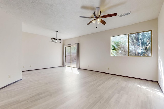 1375 Golden Eye Loop NE, Rio Rancho, NM 87144 - spare room featuring light wood-style floors, a ceiling fan, baseboards, and a textured ceiling