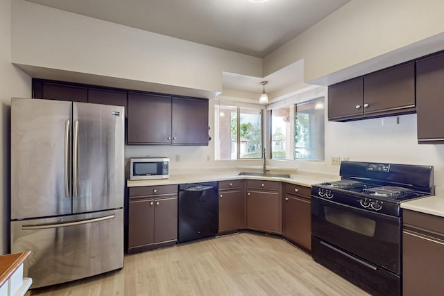 1375 Golden Eye Loop NE, Rio Rancho, NM 87144 - kitchen with black appliances, a sink, light wood finished floors, and light countertops