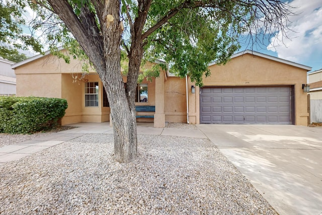 1375 Golden Eye Loop NE, Rio Rancho, NM 87144 - view of front of house featuring stucco siding, an attached garage, and driveway