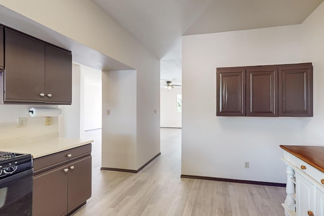 1375 Golden Eye Loop NE, Rio Rancho, NM 87144 - kitchen with black range with gas cooktop, a ceiling fan, light wood-style flooring, and dark brown cabinetry