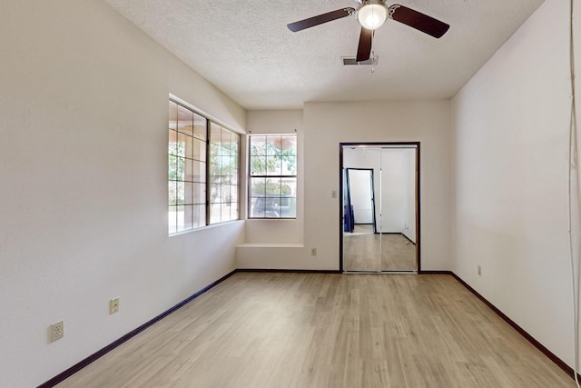 1375 Golden Eye Loop NE, Rio Rancho, NM 87144 - unfurnished room featuring light wood-type flooring, baseboards, ceiling fan, and a textured ceiling