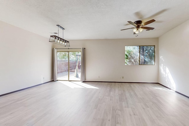 1375 Golden Eye Loop NE, Rio Rancho, NM 87144 - spare room with wood finished floors, ceiling fan, baseboards, and a textured ceiling