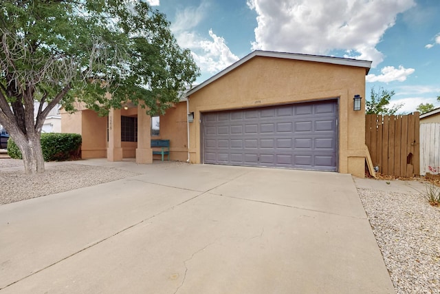1375 Golden Eye Loop NE, Rio Rancho, NM 87144 - view of front of house featuring stucco siding, concrete driveway, and a garage