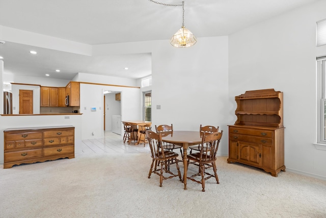 7913 Woodridge Dr NE, Albuquerque, NM 87109 - dining area featuring recessed lighting, light carpet, baseboards, and washer / dryer