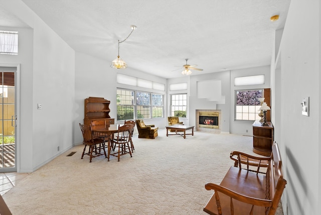 7913 Woodridge Dr NE, Albuquerque, NM 87109 - carpeted dining space with a ceiling fan, a glass covered fireplace, and baseboards