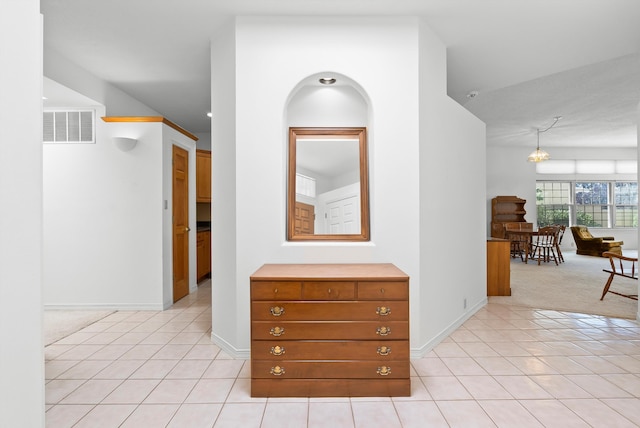 7913 Woodridge Dr NE, Albuquerque, NM 87109 - hallway featuring light tile patterned floors, baseboards, and light colored carpet