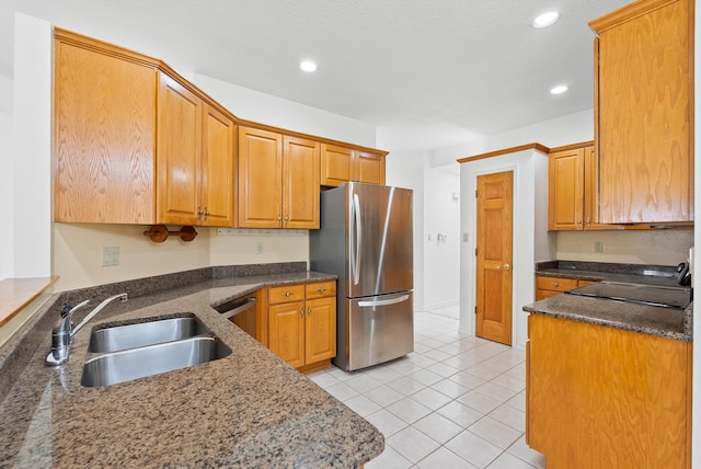 7913 Woodridge Dr NE, Albuquerque, NM 87109 - kitchen featuring stainless steel appliances, a sink, recessed lighting, light tile patterned floors, and dark stone countertops