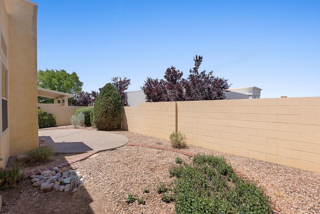 7913 Woodridge Dr NE, Albuquerque, NM 87109 - fenced backyard with a patio area