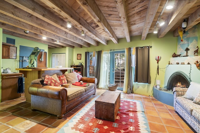 4 Pop Chalee, Glorieta, NM 87535 - tiled living area with wood ceiling with exposed beams, a lit fireplace, and track lighting