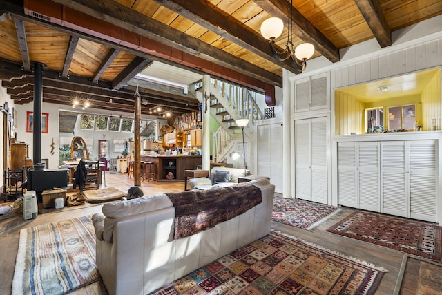 4 Pop Chalee, Glorieta, NM 87535 - living area featuring wood ceiling with exposed beams, a wood stove, stairs, and wood finished floors