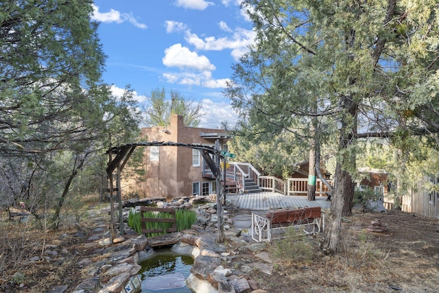 4 Pop Chalee, Glorieta, NM 87535 - view of yard featuring a wooden deck, stairs, and a small pond