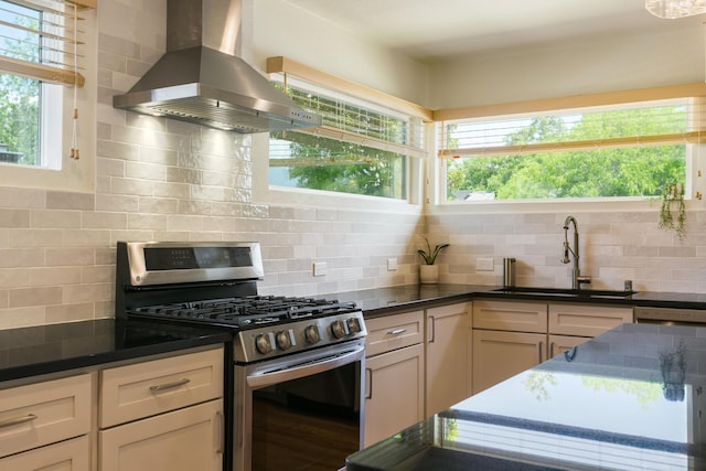 1113 California St NE, Albuquerque, NM 87110 - kitchen with stainless steel gas range, island exhaust hood, a sink, and decorative backsplash
