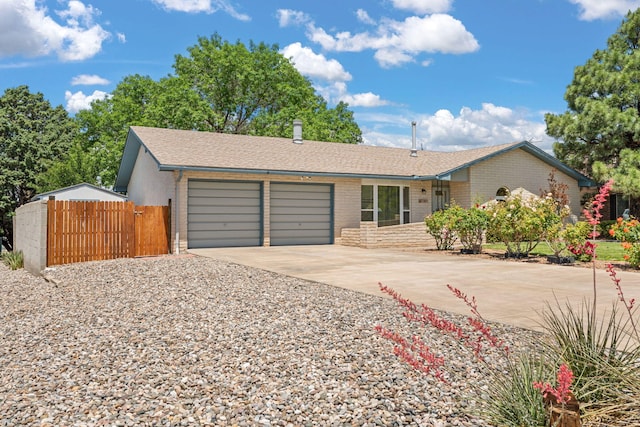 7401 Volunteer St NE, Albuquerque, NM 87109 - ranch-style home featuring concrete driveway, an attached garage, and brick siding
