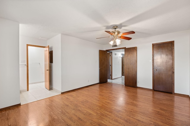 7401 Volunteer St NE, Albuquerque, NM 87109 - unfurnished bedroom with light wood-type flooring, baseboards, and ceiling fan