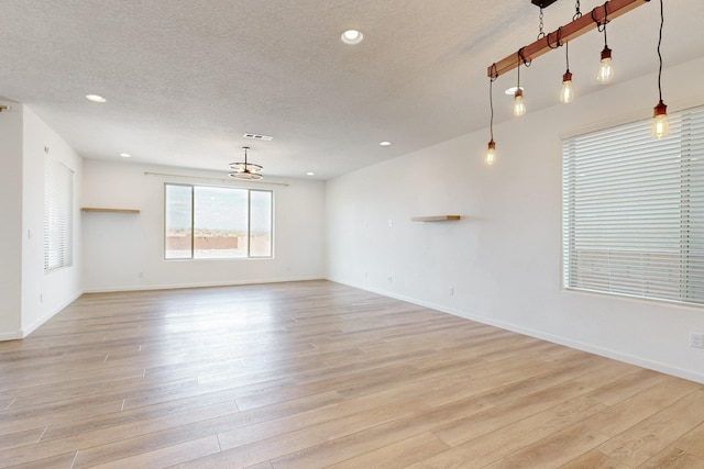 3034 Shannon Ln NE, Rio Rancho, NM 87144 - unfurnished room with light wood-style floors, a textured ceiling, recessed lighting, and baseboards