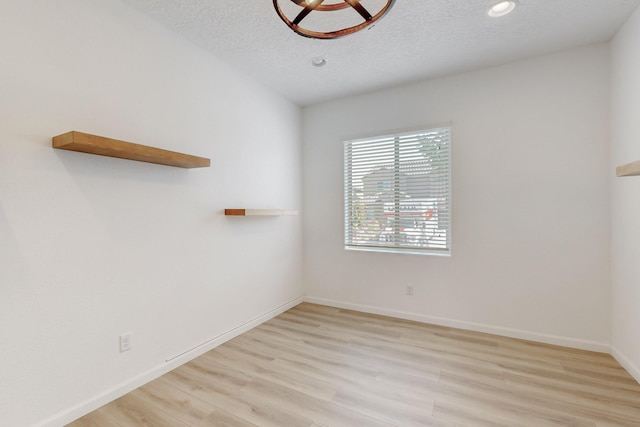 3034 Shannon Ln NE, Rio Rancho, NM 87144 - empty room with light wood finished floors, a textured ceiling, baseboards, and recessed lighting