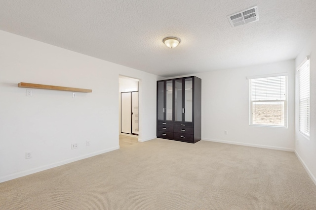 3034 Shannon Ln NE, Rio Rancho, NM 87144 - empty room with light carpet, baseboards, and a textured ceiling