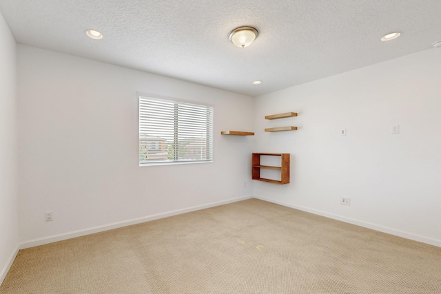 3034 Shannon Ln NE, Rio Rancho, NM 87144 - spare room featuring light colored carpet, recessed lighting, baseboards, and a textured ceiling