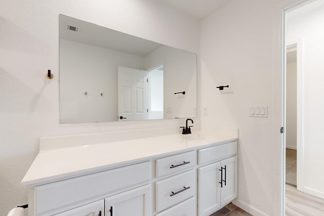 3034 Shannon Ln NE, Rio Rancho, NM 87144 - bathroom featuring vanity, wood finished floors, and baseboards
