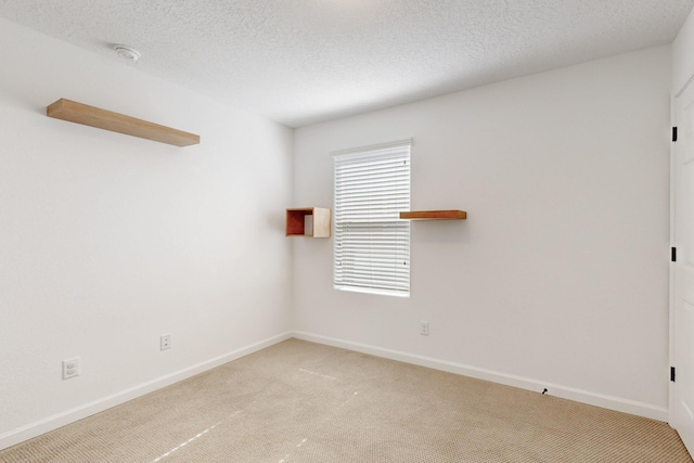 3034 Shannon Ln NE, Rio Rancho, NM 87144 - spare room with light carpet, baseboards, a smoke detector, and a textured ceiling