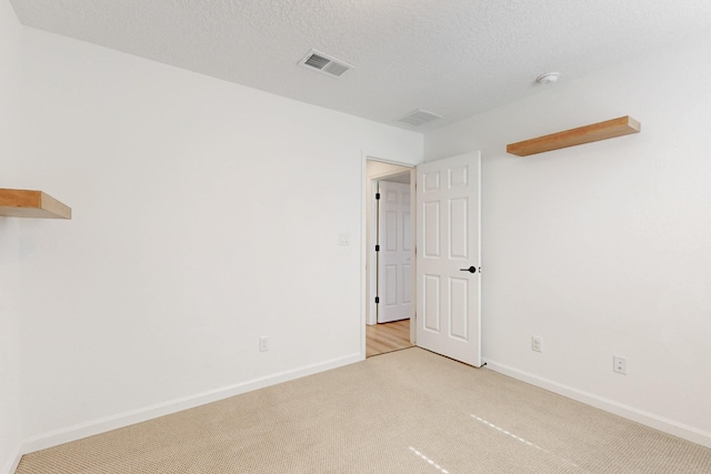3034 Shannon Ln NE, Rio Rancho, NM 87144 - spare room featuring light carpet, baseboards, a smoke detector, and a textured ceiling