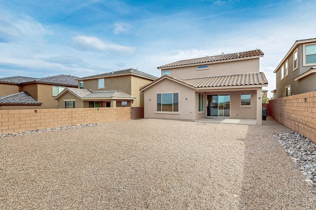 3034 Shannon Ln NE, Rio Rancho, NM 87144 - back of property with stucco siding, a fenced backyard, a tile roof, and a patio