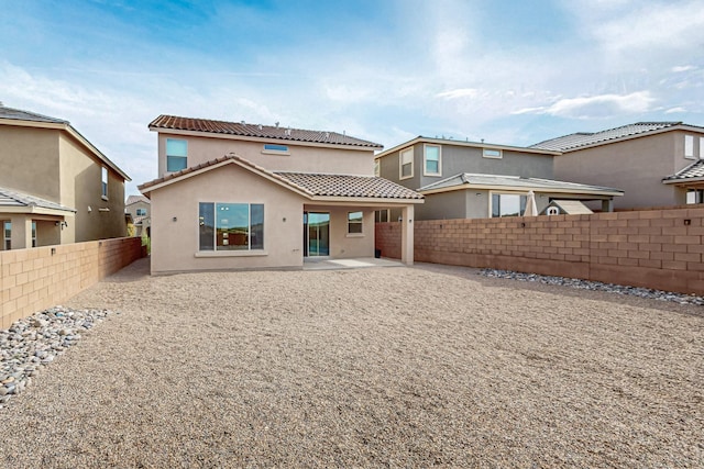 3034 Shannon Ln NE, Rio Rancho, NM 87144 - back of property featuring a tiled roof, stucco siding, a fenced backyard, and a patio