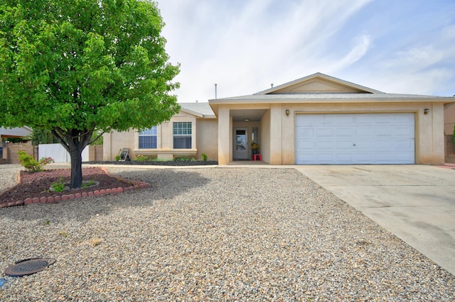 2575 Diamond Peak Dr NE, Rio Rancho, NM 87144 - ranch-style house featuring concrete driveway, stucco siding, and an attached garage