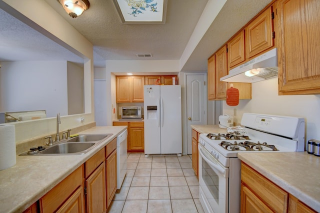2575 Diamond Peak Dr NE, Rio Rancho, NM 87144 - kitchen with white appliances, under cabinet range hood, light countertops, a sink, and light tile patterned flooring