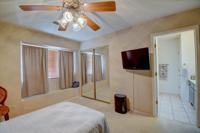 2575 Diamond Peak Dr NE, Rio Rancho, NM 87144 - bedroom featuring light carpet, ceiling fan, baseboards, and a closet