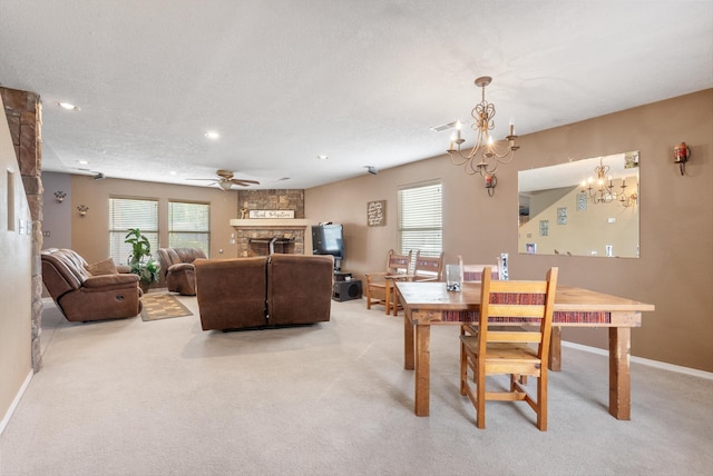 6308 Turquoise Trl NE, Rio Rancho, NM 87144 - dining space with a chandelier, light colored carpet, healthy amount of natural light, a stone fireplace, and recessed lighting