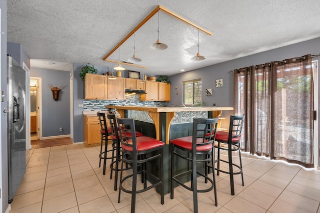 6308 Turquoise Trl NE, Rio Rancho, NM 87144 - dining space with light tile patterned flooring, a textured ceiling, and baseboards