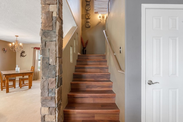 6308 Turquoise Trl NE, Rio Rancho, NM 87144 - staircase with a chandelier, a textured ceiling, and carpet flooring